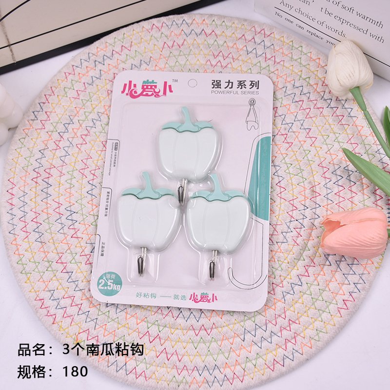 Three pumpkin - shaped sticky hooks. Sold out and then taken off the shelves.
