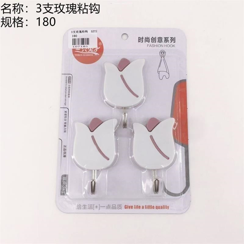 3 rose - shaped adhesive hooks. Sold out, then removed from shelves.