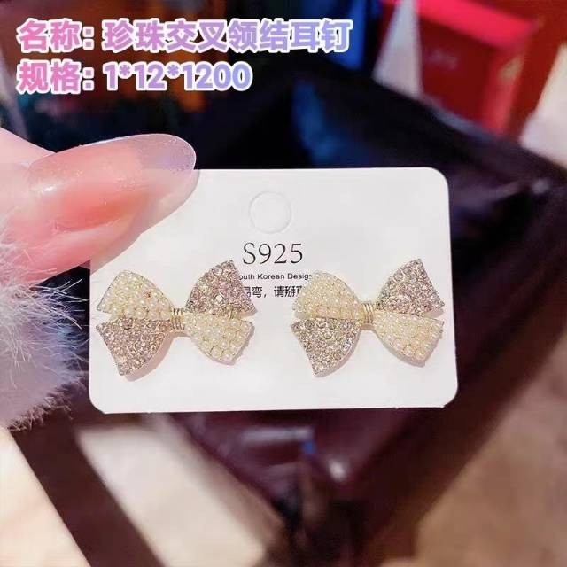 Pearl cross bow - tie stud earrings