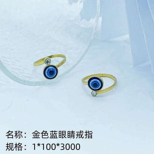 Gold ring with blue eyes