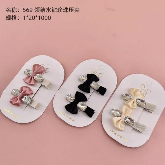569 Bow Tie Rhinestone and Pearl Press Clip
