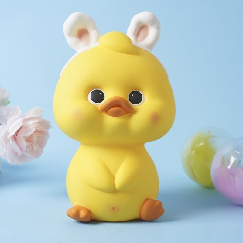 Alcancía de pato amarillo con ojos abiertos