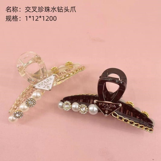Crossed pearl rhinestone head claws
