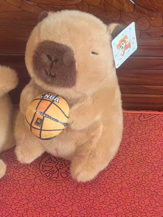 Holding a ball capybara plush
